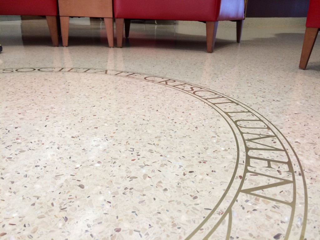 "Societate Crescit Lumen" written on the floor of the west wing in Memorial Union