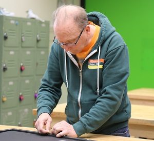 Jay working on a picture frame for a painting